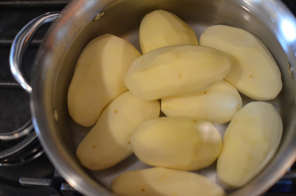 Add your potatoes to salted water and bring to a boil. 