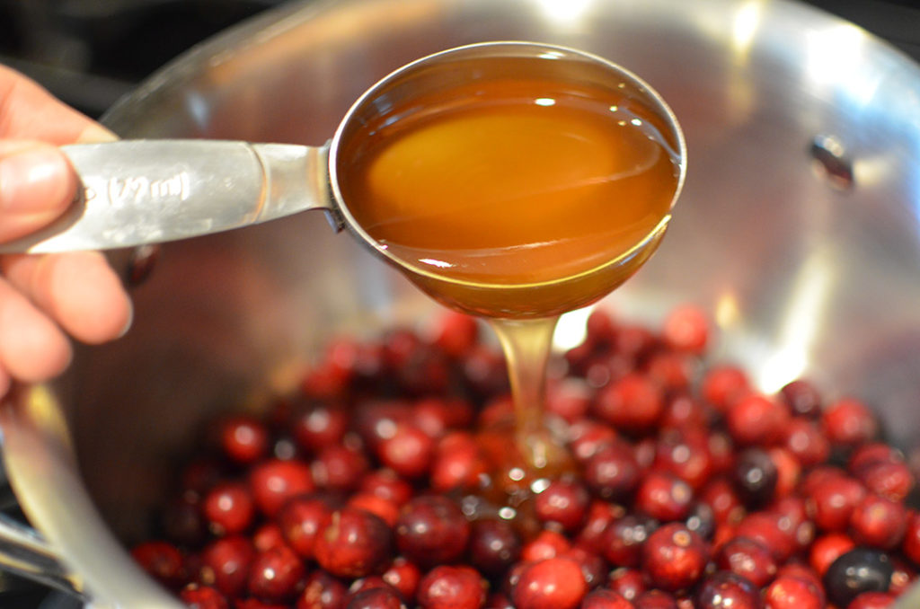 Pouring Almond Honey over Cranberries