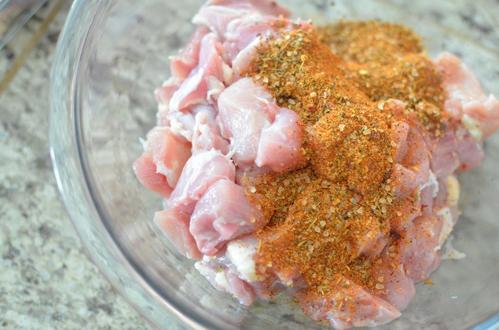 You're going to take some gloriously cajun seasoning and cover your chicken in it.
