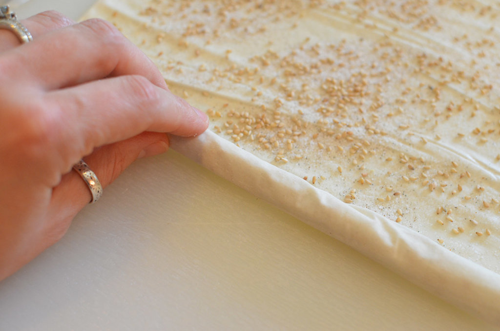 Slowly and carefully, roll your dough around the chopstick. 