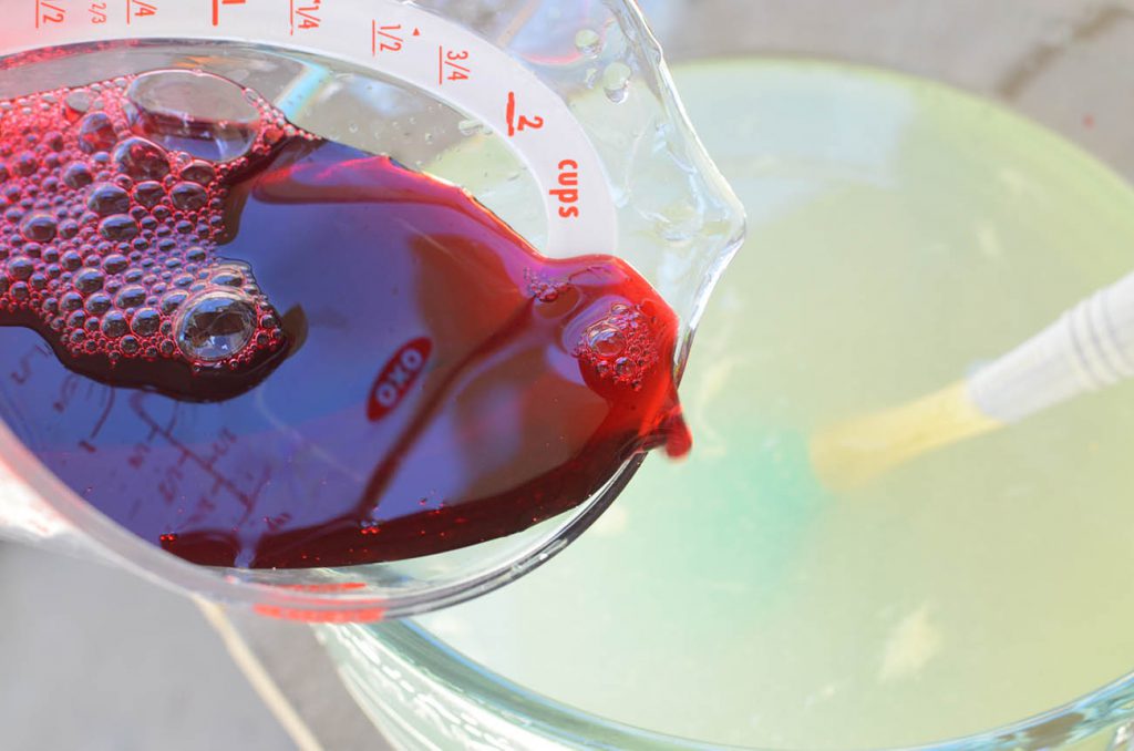 Add your hibiscus syrup! Look at the pretty color!